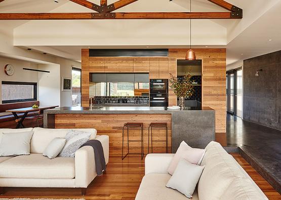 a living room with a kitchen and a large bar