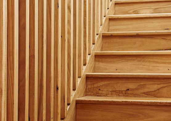 a wooden staircase with a wall behind it