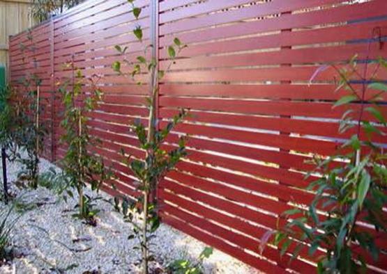 a red fence with small plants