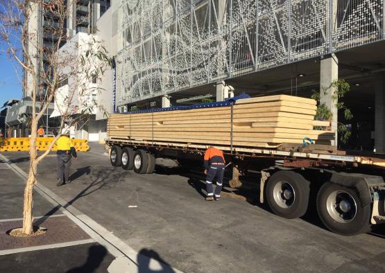 a truck with a large stack of wood on it