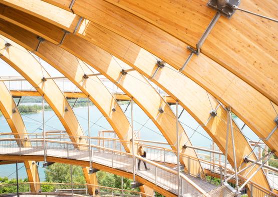 a wooden structure with a bridge and a body of water