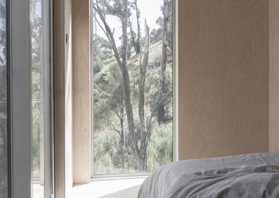 a bed with a view of trees outside
