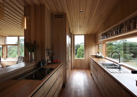 a kitchen with wood walls and cabinets