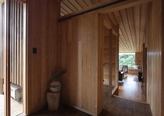 a room with wood walls and a vase