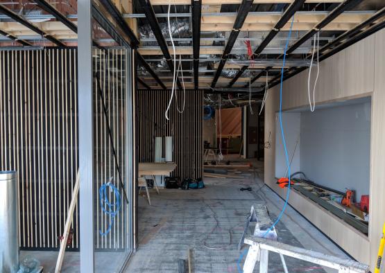 a room under construction with wood beams and wires