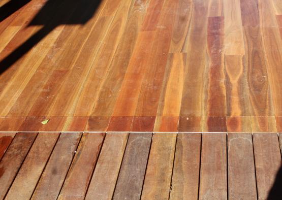 a wood deck with a shadow