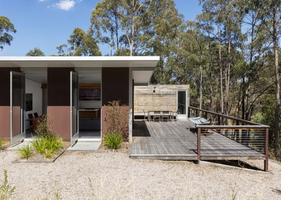 a small house with a deck and a wood deck