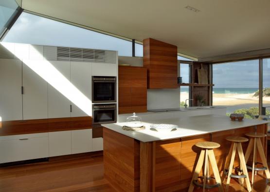 a kitchen with a large island and a large window