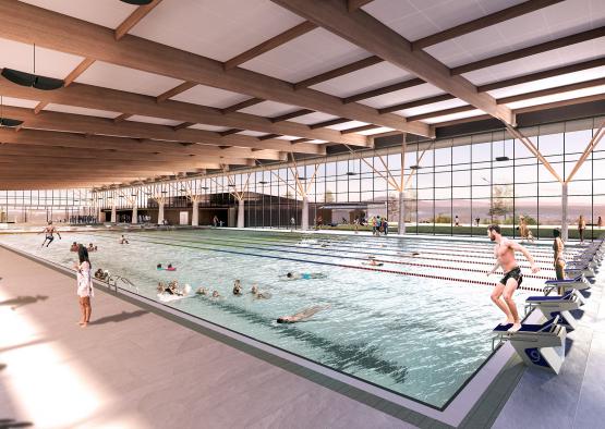 a large indoor swimming pool with people swimming in it