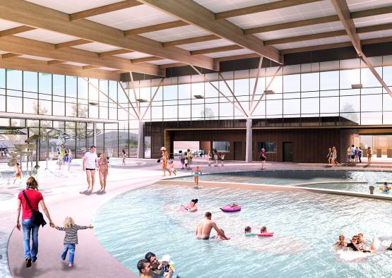 a large indoor pool with people swimming in it