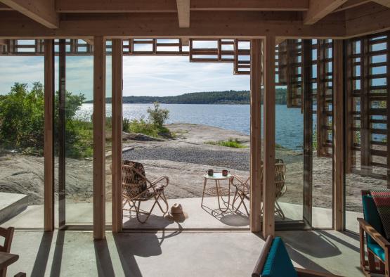 a view of a beach from a glass door