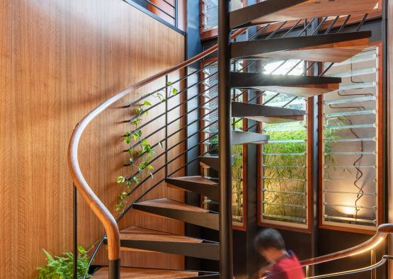 a spiral staircase with a person walking up