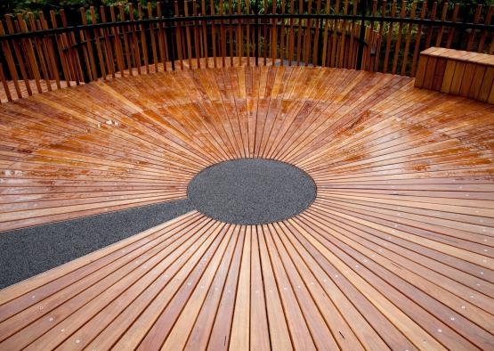 a wood deck with a circle in the center