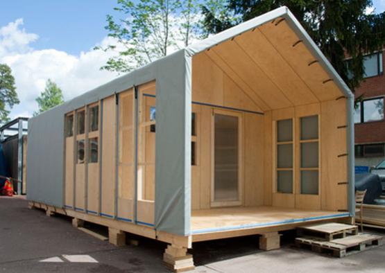 a wooden house with a grey cover