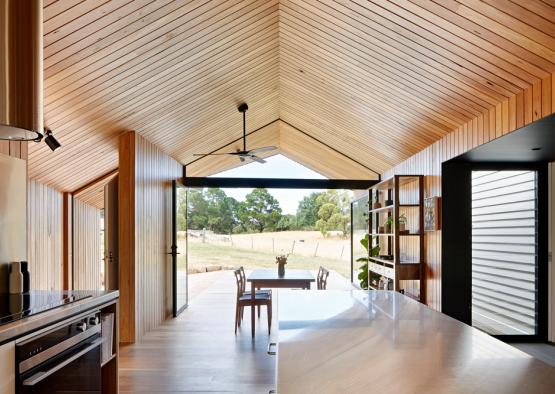 a dining table and chairs in a room with a ceiling fan