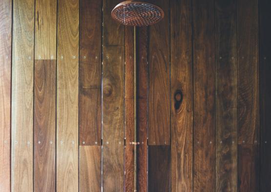 a shower head on a wood wall