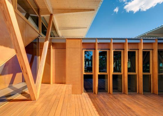 a wooden deck with glass doors