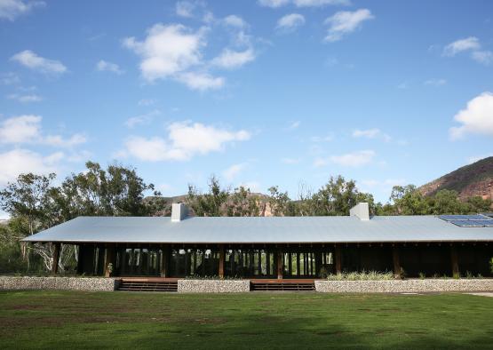 a building with a roof and grass