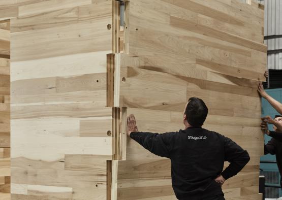 a man touching a wood wall