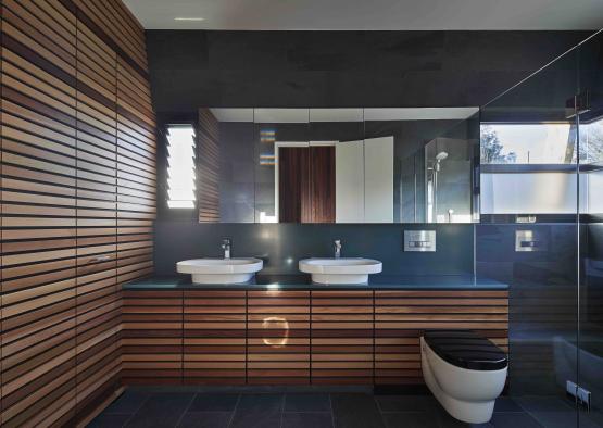a bathroom with wood cabinets and sinks