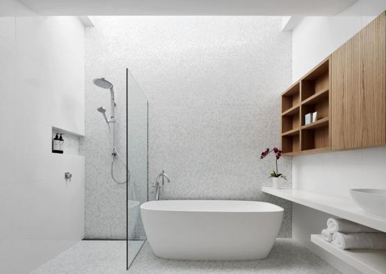 a white bathroom with a tub and shower