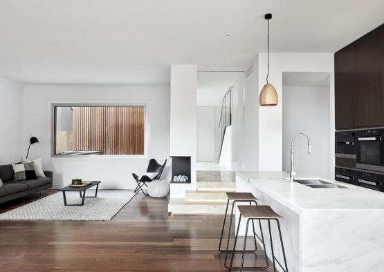 a kitchen and living room with a wood floor and a wood floor