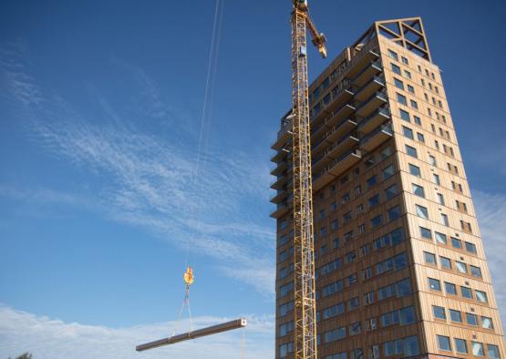 a crane lifting a metal beam