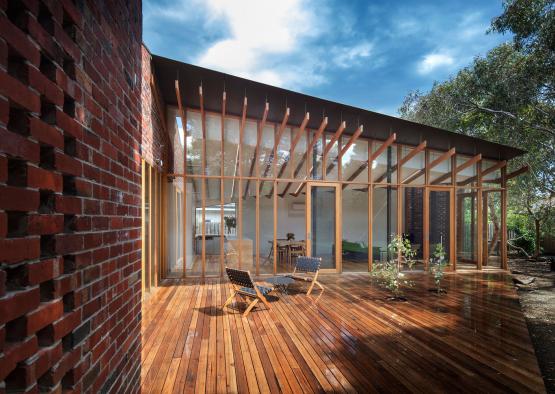 a patio with chairs and a brick wall