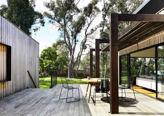 a deck with a table and chairs