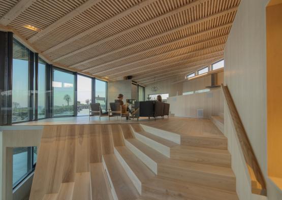 a wooden staircase in a room with windows