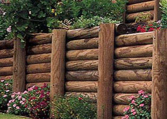 a wooden fence with flowers and plants