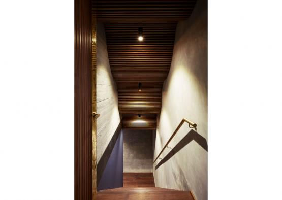 a staircase with a handrail and a light on the ceiling