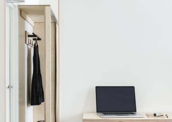 a laptop on a desk in front of a mirror