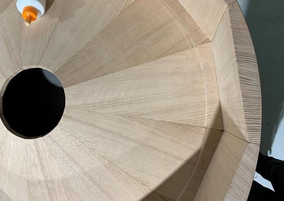 a circular wood staircase with a hole in the center