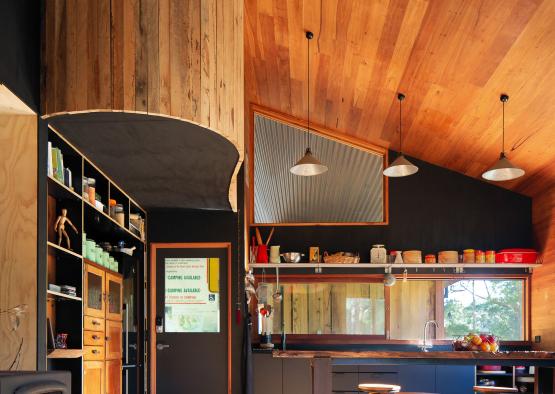 a kitchen with wood ceiling and a stove