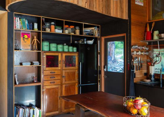 a kitchen with a table and shelves