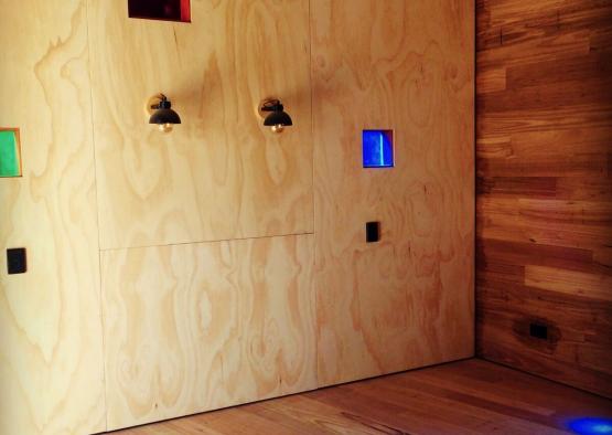 a wooden wall with lights and a wood floor