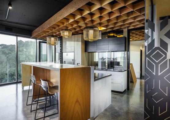 a kitchen with bar stools and lights