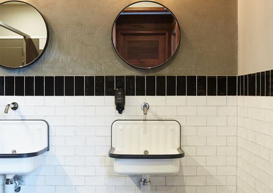 a bathroom with a sink and mirrors