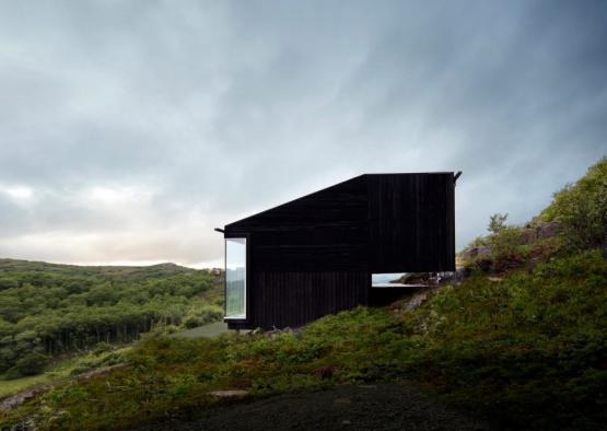 a black building on a hill