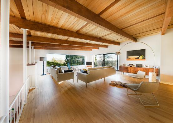 a living room with wood beams and a couch