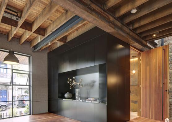 a room with a black cabinet and wood floors