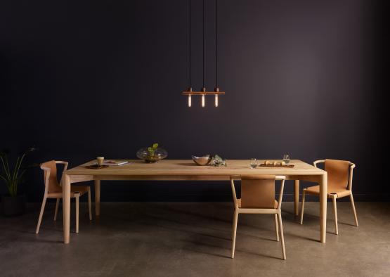 a table with chairs and a chandelier