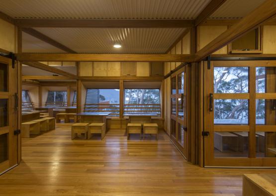 a room with wooden tables and benches