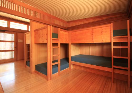 a room with bunk beds and a wood floor
