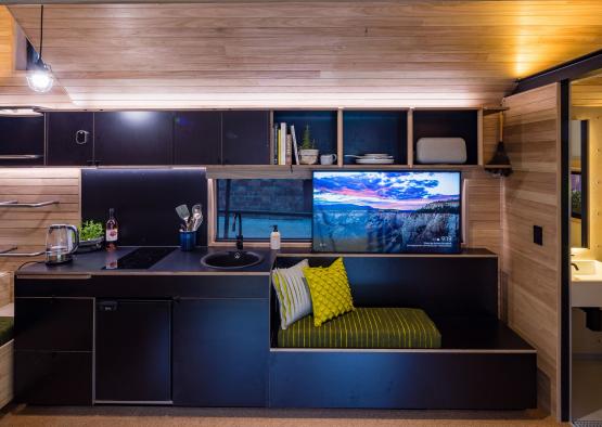 a kitchen with a couch and a tv