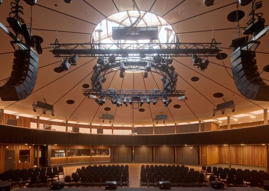 a large round auditorium with chairs and a large round ceiling