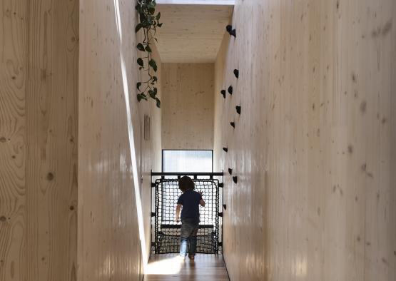 a child walking through a narrow hallway