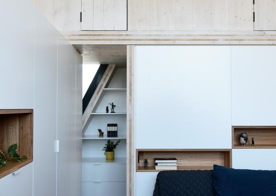 a bedroom with a bed and shelves