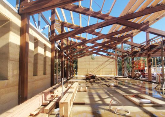 a building under construction with a wooden roof